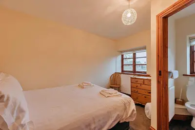 a bedroom with a bed and a sink at Finest Retreats - The Onibury in Onibury