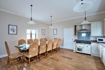 a kitchen and dining room with a table and chairs at Finest Retreats - The Park in Onibury