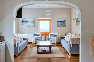 a living room with couches and a table at Finest Retreats - The Park in Onibury