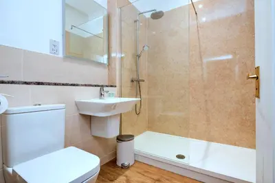 a bathroom with a shower and a toilet and a sink at Finest Retreats - The Park in Onibury