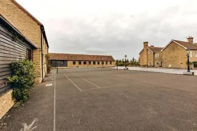an empty parking lot in front of brick buildings at Finest Retreats - Norton Cottage in Onibury