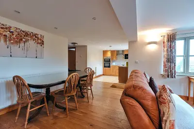 a living room with a couch and a table and chairs at Finest Retreats - Norton Cottage in Onibury