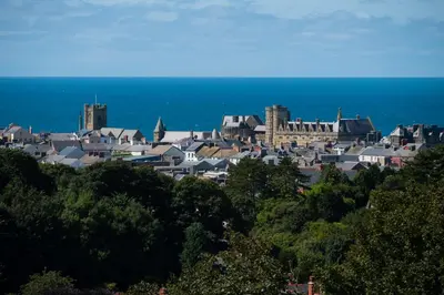 a group of buildings on a hill near the ocean at Penglais Lodge in Aberystwyth