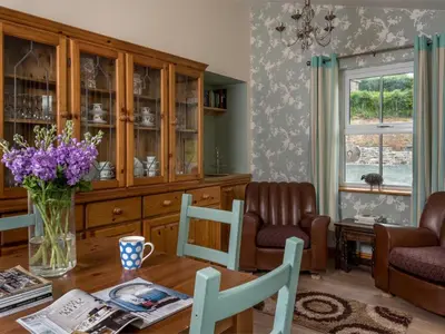 a living room with a table and chairs and a window at 4 Bed in Brecon oc-bn151 in Devynock