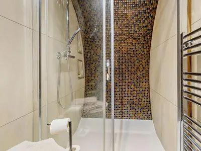 a bathroom with a shower with a glass door at 1 Bed in Llanidloes oc-81415 in Van