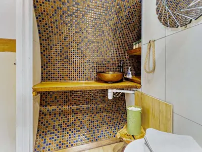 a bathroom with a tiled wall with a bowl on a shelf at 1 Bed in Llanidloes oc-81415 in Van
