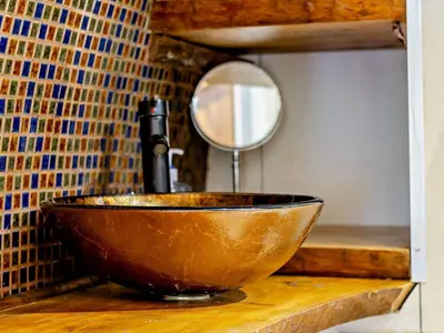 a bowl sink with a mirror on a counter at 1 Bed in Llanidloes oc-81415 in Van