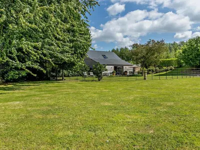 a yard with a house with a fence and trees at 2 Bed in Hereford oc-82095 in Byford