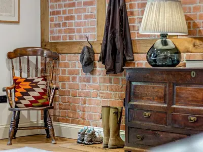 a lamp on a dresser next to a brick wall at 2 Bed in Hereford oc-82095 in Byford