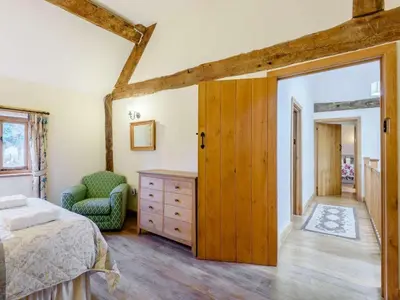 a bedroom with a bed and a chair at 4 Bed in Newtown oc-86784 in Bettws Cedewain