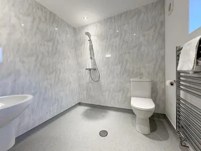 a bathroom with a toilet and a shower in it at 4 Bed in Newtown oc-86784 in Bettws Cedewain