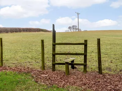 a bench in a field next to a fence at 4 Bed in Newtown oc-86784 in Bettws Cedewain