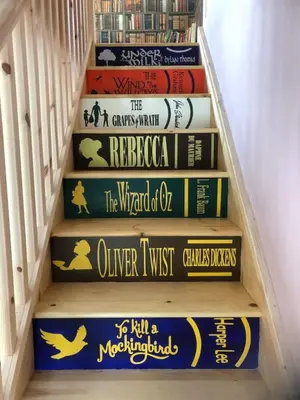 a stack of books on a stair case at Mwsogl - Luxurious Family Fishing Lodge Near Aberaeron With Private Fishing in Cross Inn
