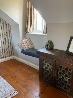 a room with a bench in the corner of a room at Rhedyn - Cosy Fishing Lodge Near Aberaeron in Cross Inn
