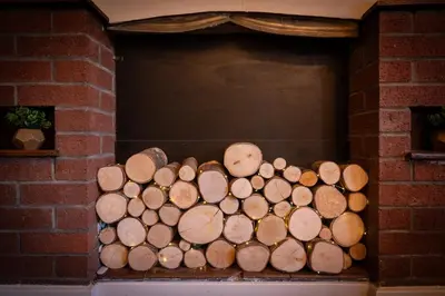 a pile of logs in a brick fireplace at Town Centre Cottage 3 Bedroom inc Parking (1 car) in Shrewsbury