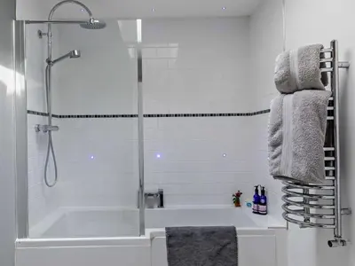 a white bathroom with a shower and a tub at 2 Bed in Leominster oc-78637 in Stoke Prior