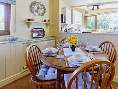 a kitchen with a wooden table with chairs and a dining room at 2 Bed in Lampeter oc-43293 in Tregaron