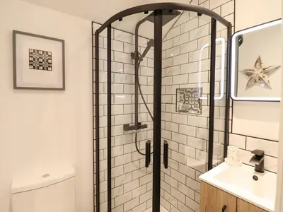 a shower with a glass door in a bathroom at Bwthyn Y Bugail in Blaenau-Ffestiniog