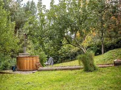 a wooden hot tub in a yard with a tree at 2 Bed in Brecon oc-59734 in Talgarth