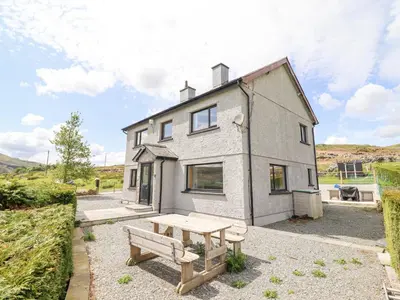 a house with a picnic table in front of it at Craig Yr Ronwy in Bala