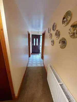a hallway in a house with plates on the walls at The Barn at the Mill in Selattyn