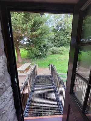 an open door with a view of a walkway at The Barn at the Mill in Selattyn