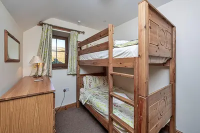 a bedroom with a bunk bed and a desk at Finest Retreats - Llechwedd Mawr in Talybont