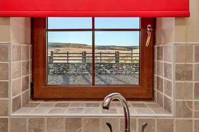 a kitchen sink with a window with a view at Finest Retreats - Llechwedd Mawr in Talybont