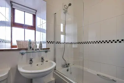 a white bathroom with a sink and a shower at Finest Retreats - Eithinog in Talybont