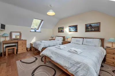 a bedroom with two beds and a desk at Finest Retreats - Helygen in Talybont