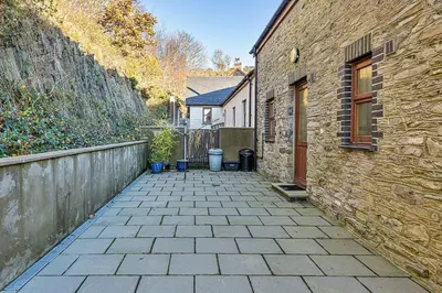 a brick walkway next to a brick building at Finest Retreats - Helygen in Talybont
