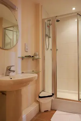 a bathroom with a sink and a shower at Fron Haul in Aberdyfi
