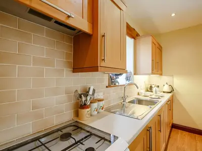a kitchen with a sink and a counter top at 1 Bed in Dyffryn Ardudwy oc-89395 in Dyffryn