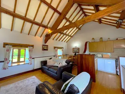 a living room with couches and a kitchen at 2 Bed in Dyffryn Ardudwy oc-89394 in Dyffryn