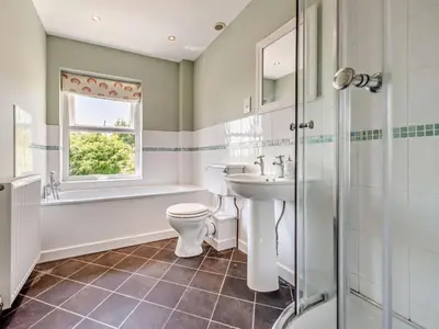 a bathroom with a toilet and a sink and a bath tub at 3 Bed in Carmarthen oc-92116 in Rhyd-cymmerau