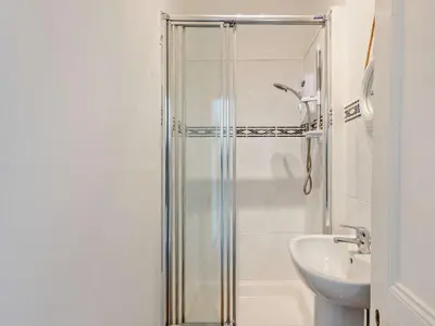 a bathroom with a shower and a sink at 4 Bed in Friog 42772 in Fairbourne