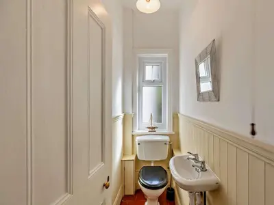 a bathroom with a toilet and a sink at 4 Bed in Friog 42772 in Fairbourne