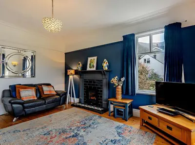 a living room with a couch and a fire place at 4 Bed in Friog 42772 in Fairbourne