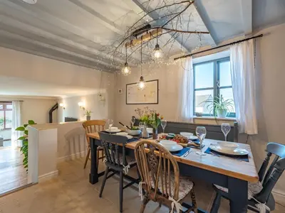 a dining room with a large wooden table and chairs at 3 Bed in Hay-on-Wye 83593 in Hay-on-Wye