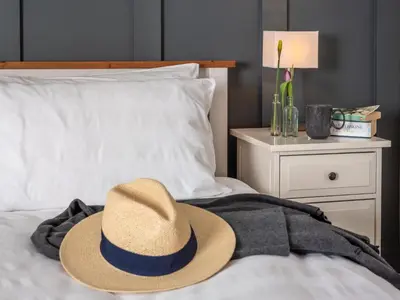 a hat sitting on top of a bed at 3 Bed in Hay-on-Wye 83593 in Hay-on-Wye