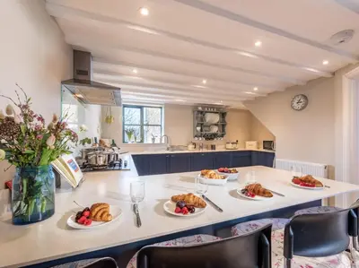 a kitchen with a table with plates of food on it at 3 Bed in Hay-on-Wye 83593 in Hay-on-Wye