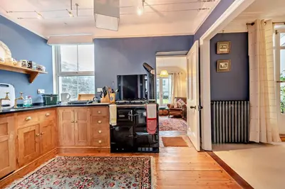 a kitchen with blue walls and a stove in a room at 3 Bed in Aberaeron oc-b27954 in Aberaeron