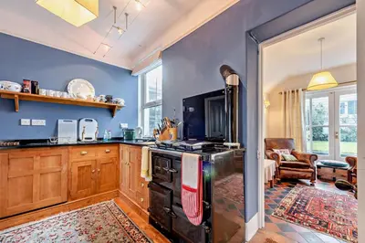 a kitchen with a stove top oven in a room at 3 Bed in Aberaeron oc-b27954 in Aberaeron