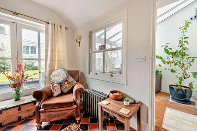 a living room with a chair and a table at 3 Bed in Aberaeron oc-b27954 in Aberaeron
