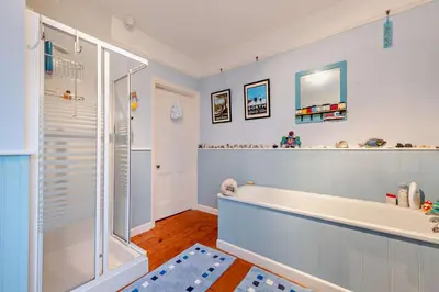 a bathroom with a bath tub and a shower at 3 Bed in Aberaeron oc-b27954 in Aberaeron