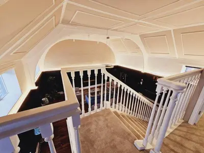 a staircase in a house with a white ceiling at Unique town centre apartment with vaulted ceiling - Pass the Keys in Shrewsbury