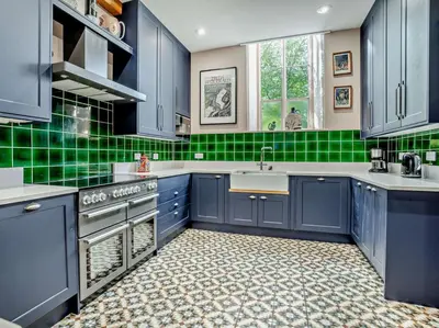 a kitchen with blue cabinets and green tile floors at 4 Bed in Hereford oc-80464 in Glasbury