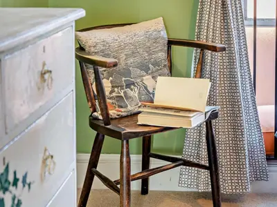 a chair with a laptop and books on it at 4 Bed in Hereford oc-80464 in Glasbury