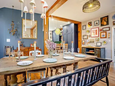 a dining room with a large wooden table with chairs at 4 Bed in Hereford oc-80464 in Glasbury