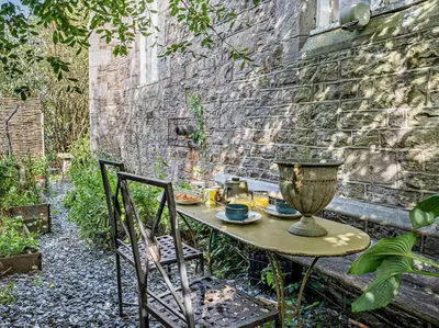 a table and chairs in front of a brick wall at 4 Bed in Hereford oc-80464 in Glasbury